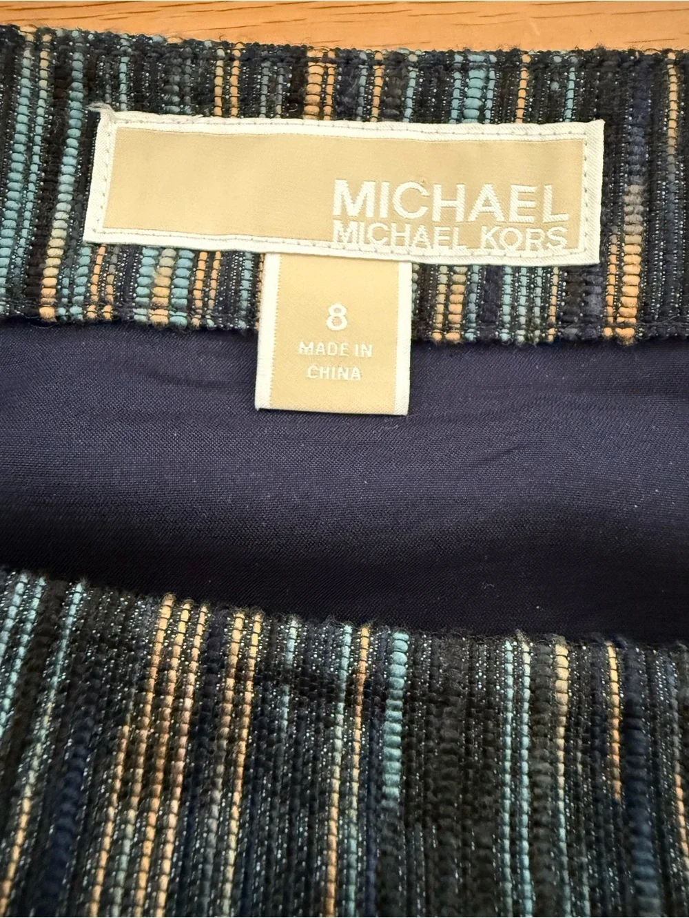 Michael Kors parentheses (white main label with silver lettering)